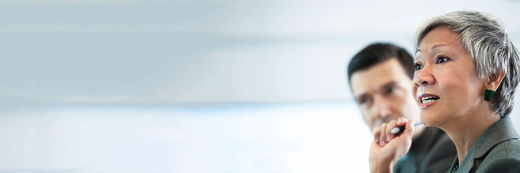 Closeup of woman in foreground with man in background