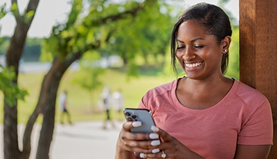 Woman smiling at her phone