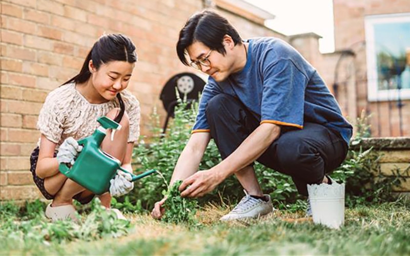 Father and daughter gardening together