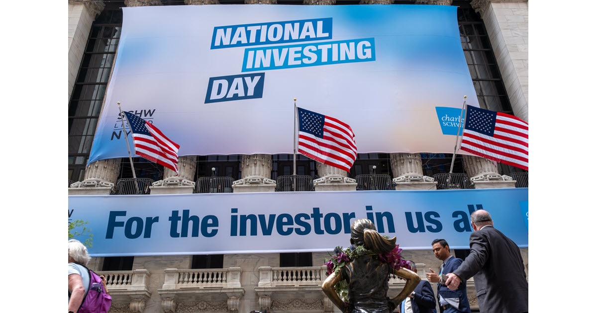 A National Investing Day banner covers the front of the New York Stock Exchange.