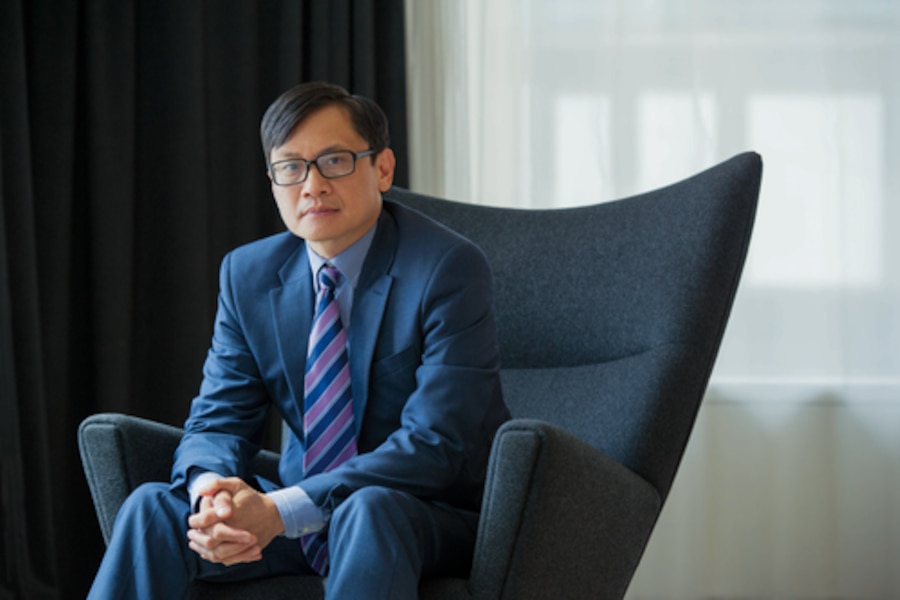 man in a suit sitting a chair