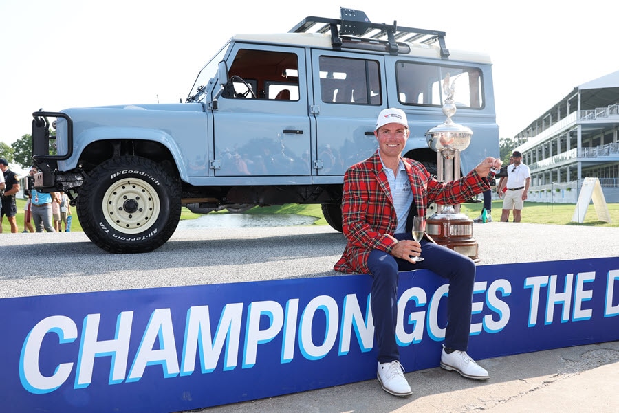 Ben Griffin posing with the Charles Schwab Challenge prize car.