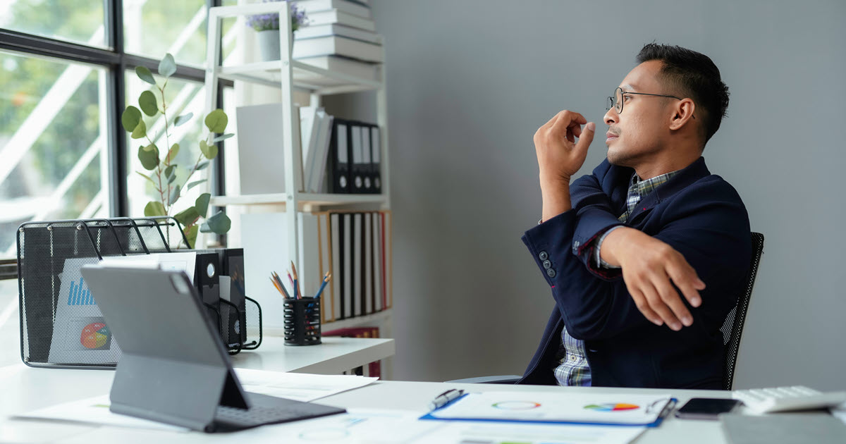 Man stretching at his desk
