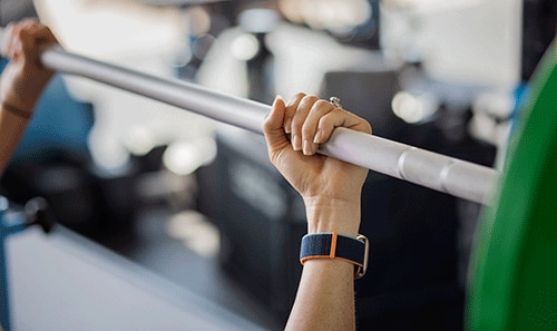 Person holding a weight bar
