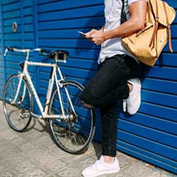 Young adult leaning against the wall.