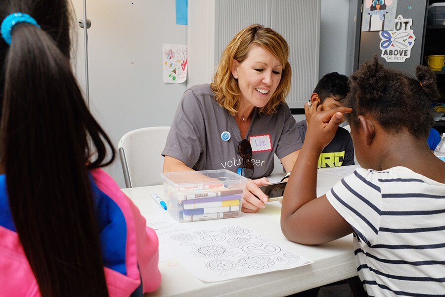 Schwab volunteer talking to a student
