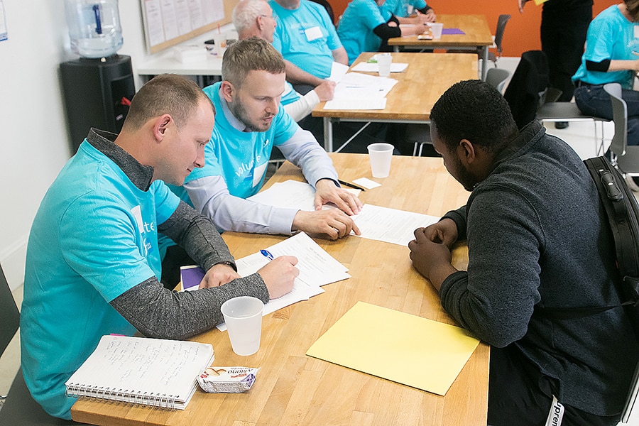 Schwab volunteers helping a Stride Center client