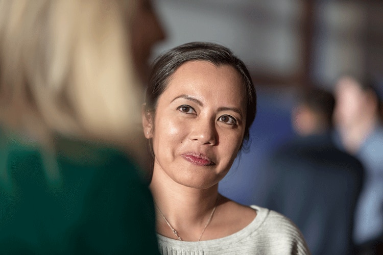 A woman listening to another woman speak.