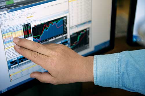Person looking at stock data on the computer.