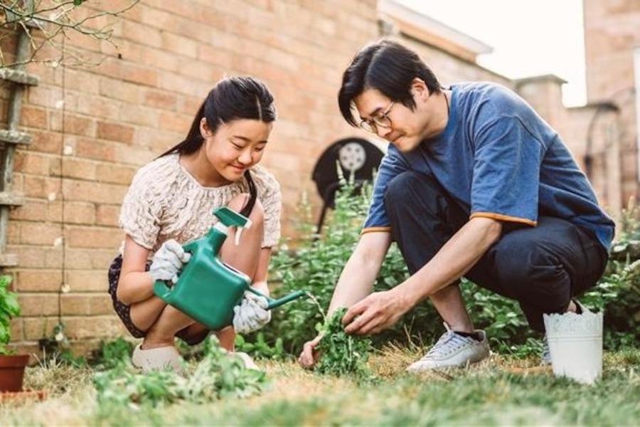 father and daughter planting a garden