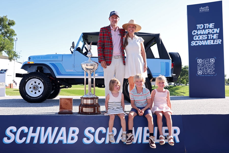 Russell Henley poses with his family in front of the Schwab Scrambler prize car.