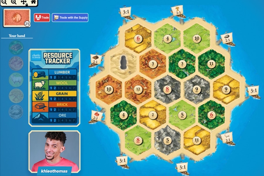 Image of a gaming screen with a digital Catan board and the face of influencer Khleo Thomas in the bottom left hand corner.