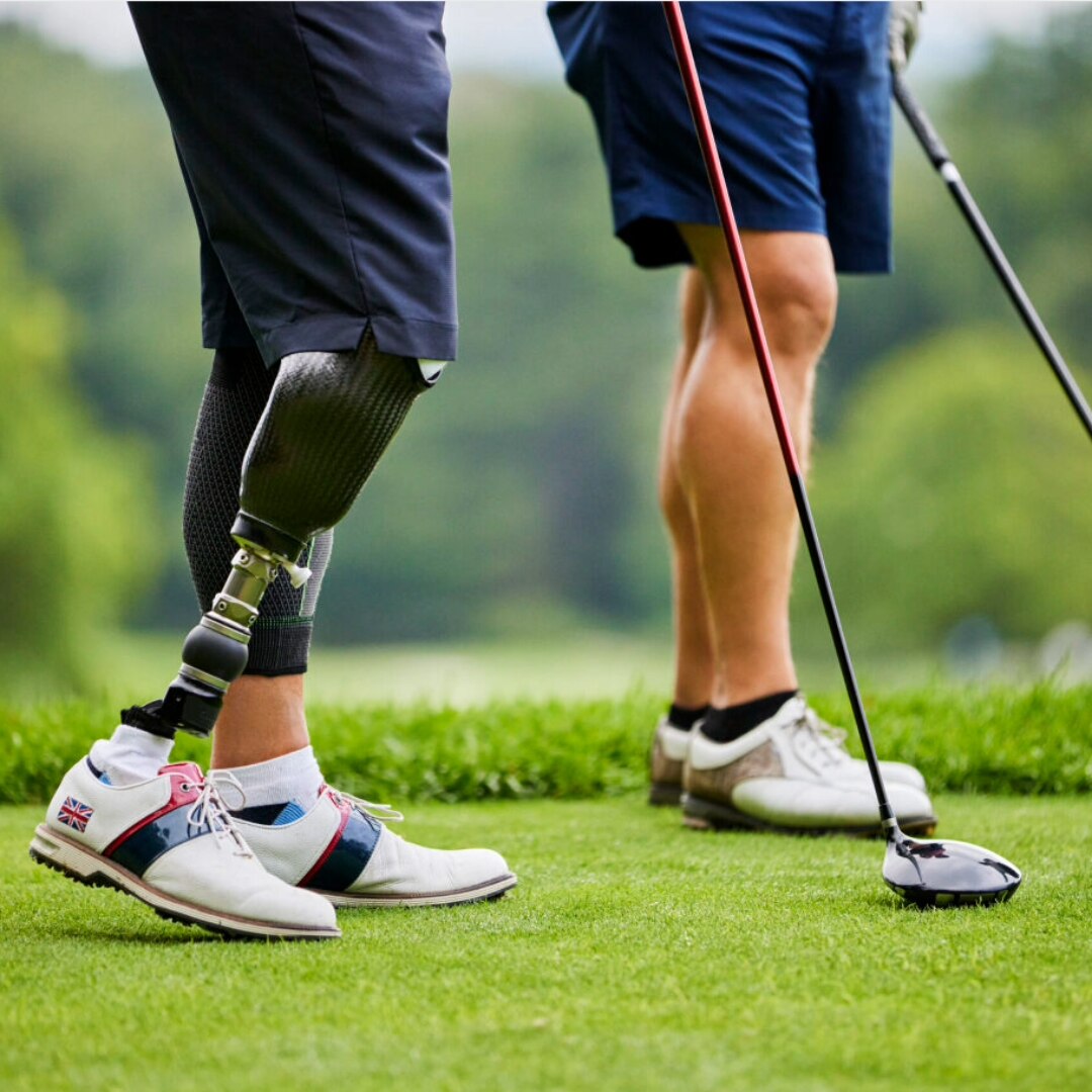 Man with prosthetic leg swinging a golf club 