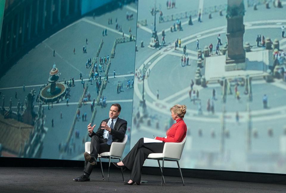 Two people on stage having a discussion.