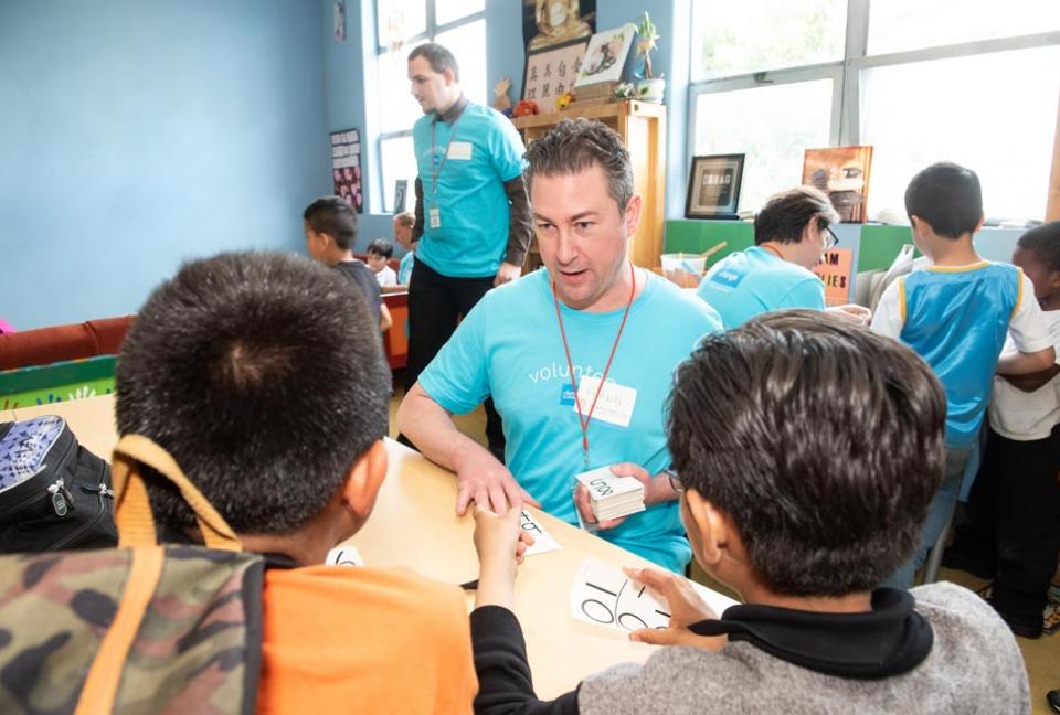Schwab volunteer teaching students