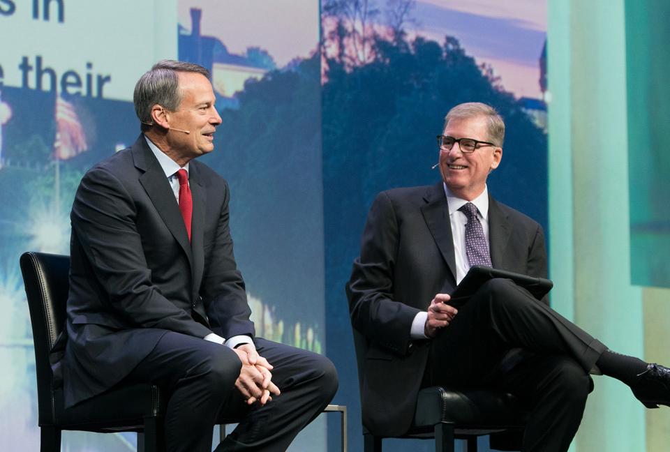 Walt Bettinger, President and CEO and Bernie Clark, head of Schwab Advisor Services, talking on stage.
