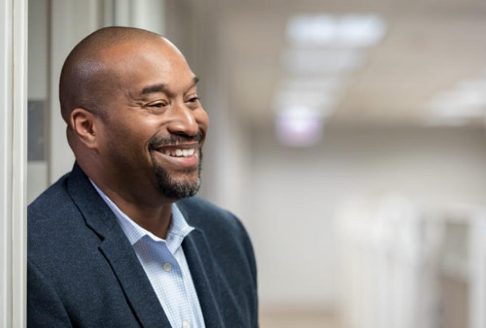 Smiling man standing outside an office