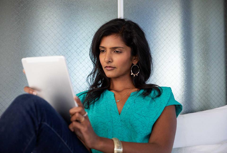 Woman looking at her tablet.