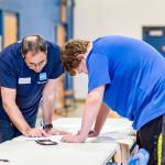 A Schwab volunteer helping a student