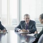 Group of professionals around a table.