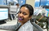 Smiling woman with headset at her desk